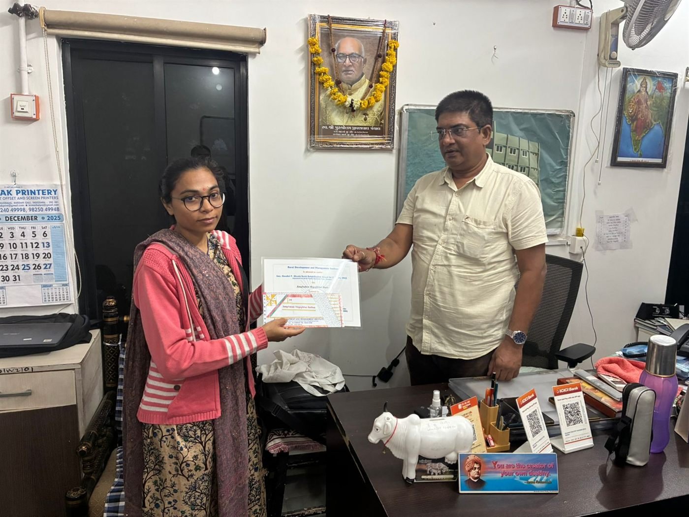 A trainee receiving her vocational training certificate at the Seva Tirth office